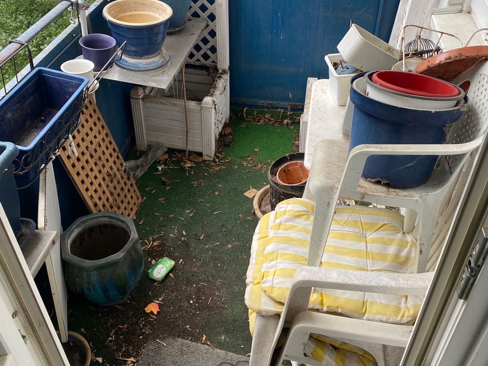 Balkon voller Pflanzkübel und Gartenmöbel vor der Räumung